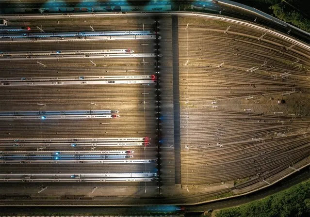 Aerial photo shows bullet trains on the Nanjing South Bullet Train parking line in Nanjing, Jiangsu province, China, early on June 30, 2023. From midnight on July 1, the national railway will implement a new train operation map, and at the same time, the 2023 summer rush (July 1 to August 31) will also be officially launched. After the adjustment of the map, the national railway arrangement plan has 10,592 passenger trains, an increase of 46 trains compared with the current map. A total of 22,182 cargo trains were put into operation, an increase of 394 over the current figure, and the railway passenger and cargo transport capacity, service quality and operation efficiency were further improved. (Photo by Costfoto/NurPhoto/Rex Features/Shutterstock)