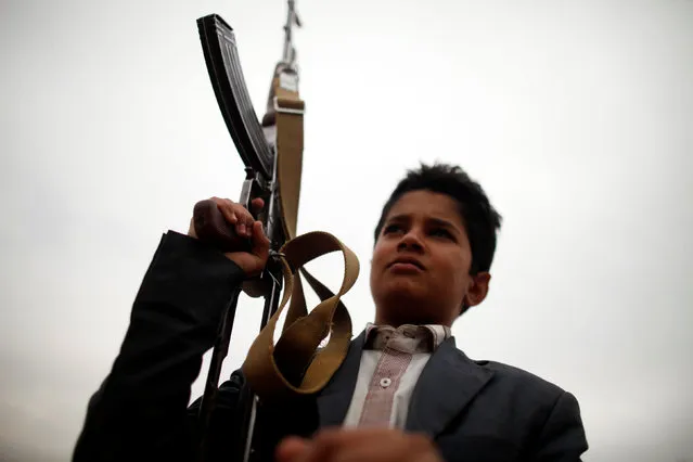 A boy carries a weapon during a tribal gathering held to show support to the Houthi movement in Sanaa, Yemen November 10, 2016. (Photo by Khaled Abdullah/Reuters)