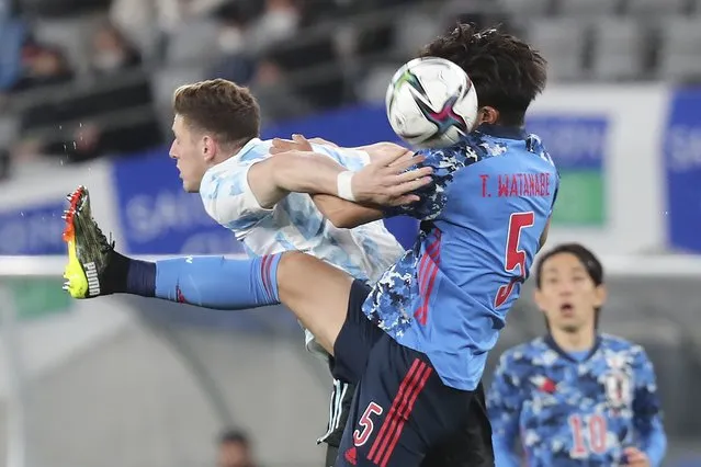 Adolfo Gaich of Argentina left, and Tsuyoshi Watanabe of Japan battle for the ball during their international friendly soccer match between Japan and Argentina in Tokyo, Friday, March 26, 2021. (Photo by Koji Sasahara/AP Photo)