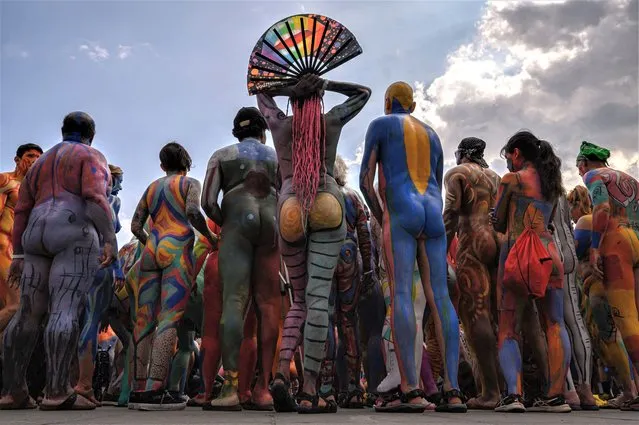 Participants pose for photos during a “body-painting day” event intended to take advantage of a New York law allowing public nudity for artistic purposes in New York City on July 23, 2023. (Photo by Ed Jones/AFP Photo)