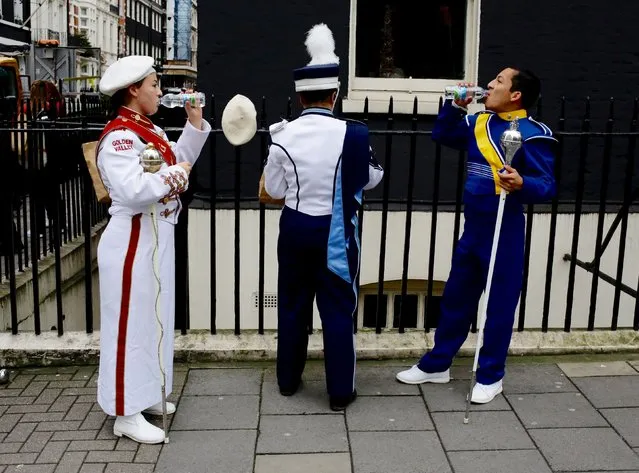 Performers take a drink at the start of the New Year's Day Parade in London, January 1, 2016. (Photo by Kevin Coombs/Reuters)