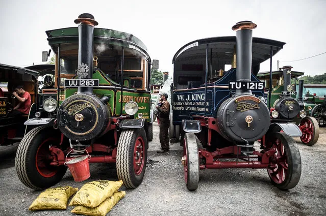 Two steam wagons sit as they get up to pressure as dozens of steam powered vehicles gather at a pub in Dorset, UK on August 19, 2018, prior to making their way to the Great Dorset Steam Fair, where hundreds of period steam traction engines and heavy mechanical equipment from all eras gather for the annual show on 23 to 27 August 2018, to celebrate 50 years. (Photo by Ben Birchall/PA Wire)