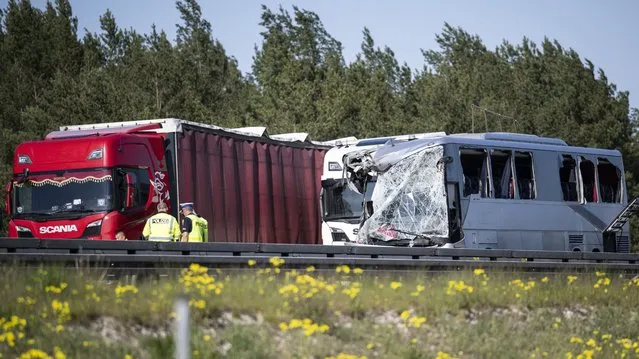 A polish coach stands damaged on the A12 highway after a serious accident in Dannenreich, near Berlin, Germany, Tuesday, May 9, 2023. A highway collision between a long-distance Polish bus and a truck has injured dozens of people in eastern Germany. (Photo by Hannes P. Albert/dpa via AP Photo)