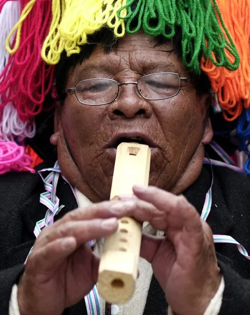 An indigenous man plays a “Tarka”, a native instrument, during the Anata Andina (Andean carnival) parade in Oruro, February 12, 2015. (Photo by David Mercado/Reuters)