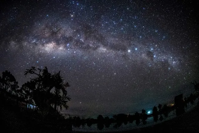 A long exposure photo shows the Milky Way galaxy star cluster from Tuban village in Badung, on Indonesia's resort island of Bali on March 23, 2023 during Nyepi, the day of silence, when Hindus do not work, travel or take part in any indulgence. (Photo by Dicky Bisinglasi/AFP Photo)