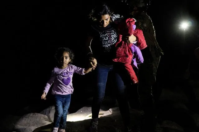An asylum-seeking migrant family disembark from an inflatable raft after crossing the Rio Grande river into the United States from Mexico in Roma, Texas, U.S. May 5, 2021. (Photo by Go Nakamura/Reuters)