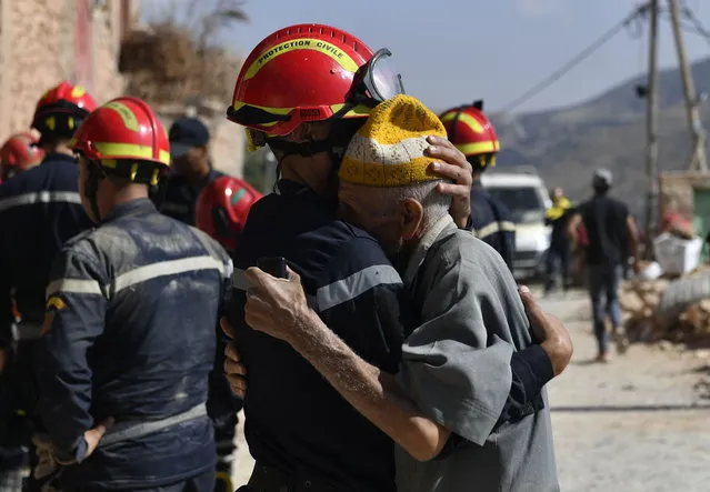 A man hugs a member of the civil protection team as they prepare to recover bodies of victims from a collapsed building, Imi Ntala, Amizmiz, south of Marrakesh, Morocco, 13 September 2023. A magnitude 6.8 earthquake that struck central Morocco late 08 September has killed more than 2,900 people and injured thousands, damaging buildings from villages and towns in the Atlas Mountains to Marrakech, according to a report released by the country's Interior Ministry. The earthquake has affected more than 300,000 people in Marrakech and its outskirts, the UN Office for the Coordination of Humanitarian Affairs (OCHA) said. Morocco's King Mohammed VI on 09 September declared a three-day national mourning for the victims of the earthquake. (Photo by Jalal Morchidi/EPA)