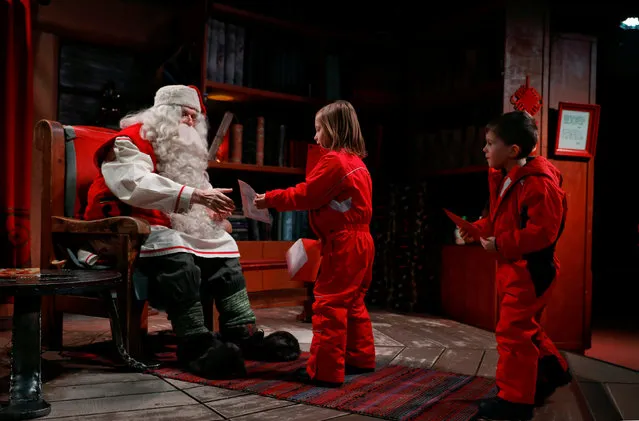 Santa Claus talks to Eloise and Noah Seymour from England at Santa Claus' Village in the Arctic Circle near Rovaniemi, Finland December 15, 2016. (Photo by Pawel Kopczynski/Reuters)