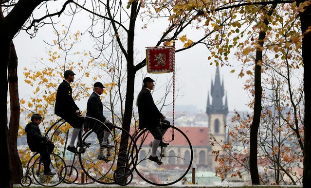Participants wearing historical costumes ride their high-wheel bicycles during the annual penny farthing race in Prague, Czech Republic November 3, 2018. (Photo by David W. Cerny/Reuters)
