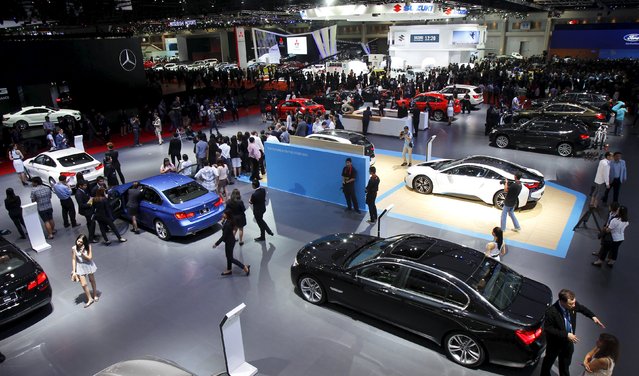 Visitors gather around displays during a media presentation of the 36th Bangkok International Motor Show in Bangkok March 24, 2015. (Photo by Chaiwat Subprasom/Reuters)