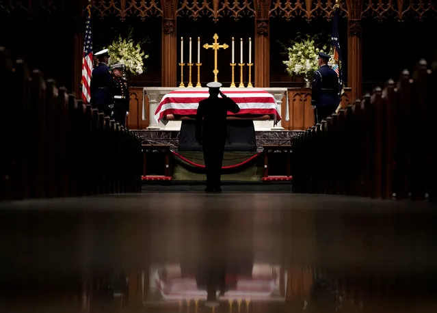 People pay their respects as the flag-draped casket of former President George H.W. Bush lies in repose at St. Martin's Episcopal Church Wednesday, Dec. 5, 2018, in Houston. (Photo by David J. Phillip/Pool via Reuters)