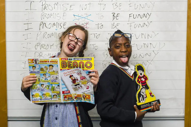 Pupils (left to right) Mia Smith and Vuyo Mdlalose from class 5B at Forthill Primary school in Dundee, eastern Scotland with the trophy on Thursday, July 15, 2021, as their class is unveiled as this year's winners of Beano's “Britain's Funniest Class” national joke competition. (Photo by Euan Cherry/PA Wire Press Association)
