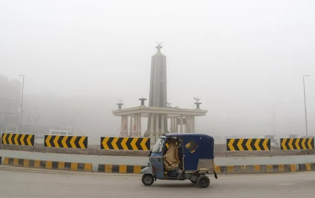A rickshaw is driven around a roundabout on the ring road in Peshawar, Pakistan January 22, 2016. (Photo by Khuram Parvez/Reuters)