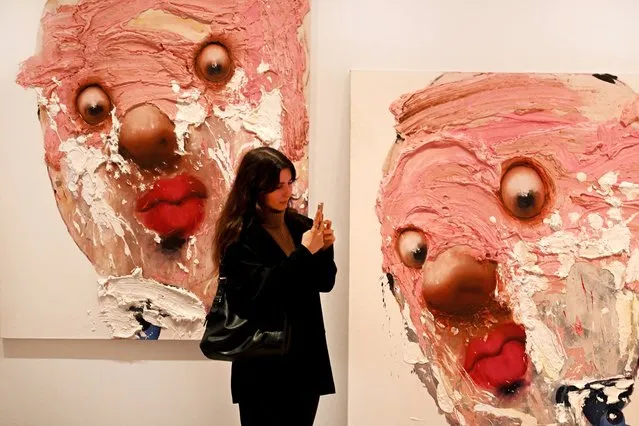 A woman inspects artwork by Iranian artist Farrokh Mahdavi during a preview of the National Gallery of Victoria's (NGV) Triennial 2023, an exhibition featuring work by over 120 contemporary artists, designers and collectives, in Melbourne on December 1, 2023. (Photo by William West/AFP Photo)