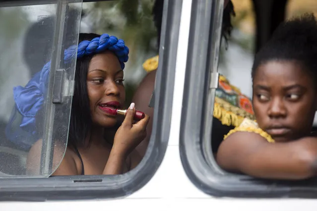 A dancer applies lipstick onboard a bus before the start of the Carnival parade in the Carrefour district of Port-au-Prince, Haiti, Tuesday, March 5, 2019. (Photo by Dieu Nalio Chery/AP Photo)