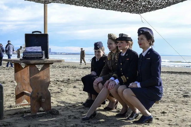 World War II enthusiasts take part in a re-enactament to mark the 70th anniversary of the Allied landings on Anzio beach, 52 km south of Rome, on January 25, 2014. (Photo by Andreas Solaro/AFP Photo)
