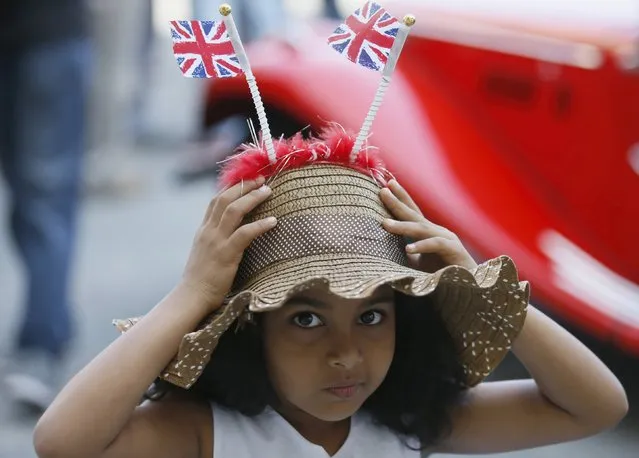 A girl wears a hat with two small British national flags during the annual “British Car Day” celebrations in Colombo, Sri Lanka March 13, 2016. (Photo by Dinuka Liyanawatte/Reuters)