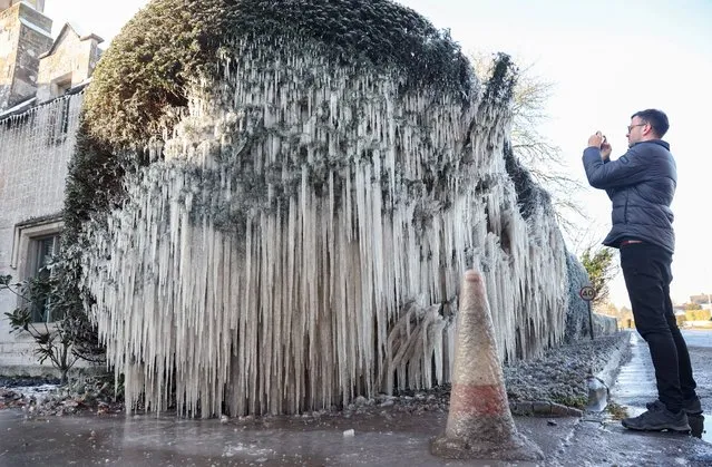 A burst water main has created wonderful frozen icicles on hedges surrounding a property in Staunton, Gloucestershire, United Kingdom on December 16, 2022. (Photo by South West News Service)