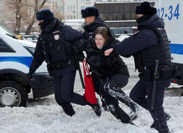 Police officers detain a woman during a gathering in memory of Russian opposition leader Alexei Navalny near the Wall of Grief monument to the victims of political repressions in Moscow, Russia on February 17, 2024. (Photo by Reuters/Stringer)