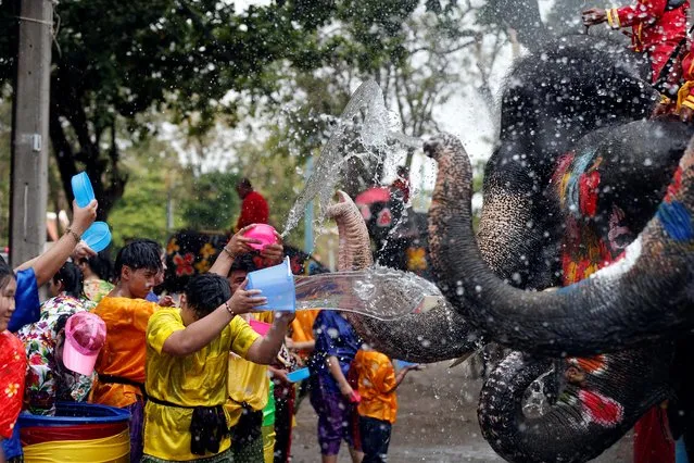 Elephants and people play with water as part of celebrations for the water festival of Songkran in Ayutthaya, Thailand on April 11, 2019. (Photo by Soe Zeya Tun/Reuters)