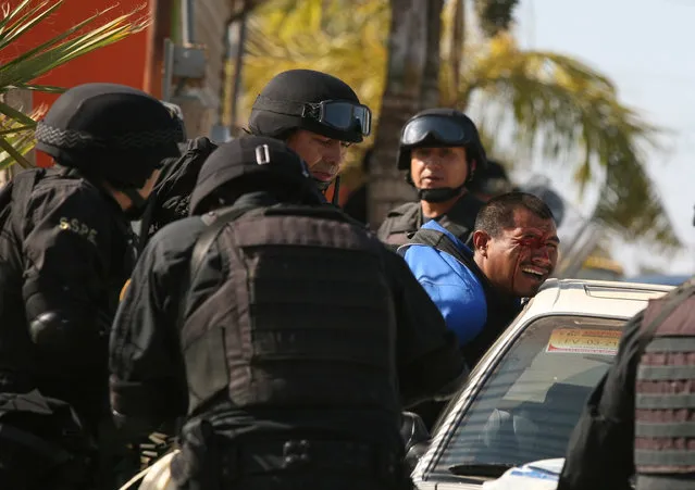 A man is detained by state police after workers of tomato farm labor camps allegedly invaded private property, according to state police, in the town of San Quintin, on Mexico's Baja peninsula, Saturday, May 9, 2015. Dozens of workers were injured in the clash, some seriously, according to a spokesman of the National, State and Municipal Alliance for Social Justice. (Photo by Roberto Armocida/La Jornada Baja California via AP Photo)