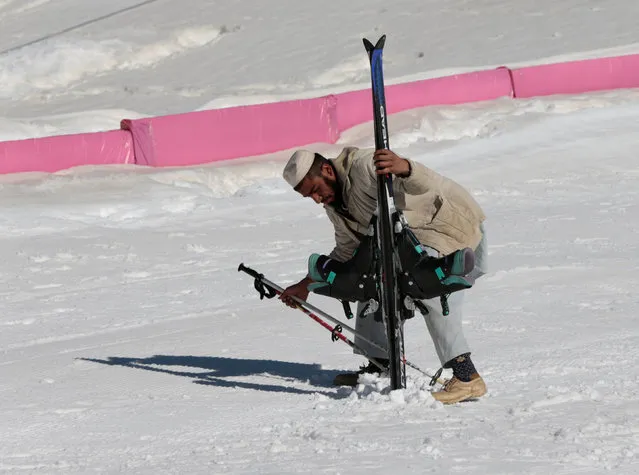 A man picks up a set of skis and boots at the ski resort in Malam Jabba, Pakistan February 7, 2017. (Photo by Caren Firouz/Reuters)