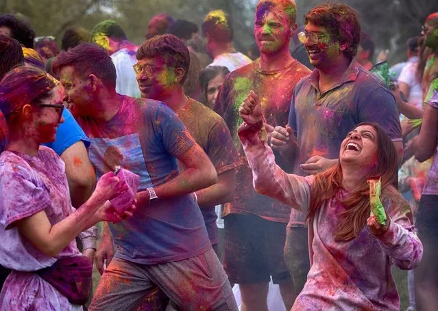 Devotees dance and throw colored powder as they celebrate Holi, the Hindu festival of colors, in the Encino section of Los Angeles on Sunday, March 24, 2024. (AP Photo/Richard Vogel)