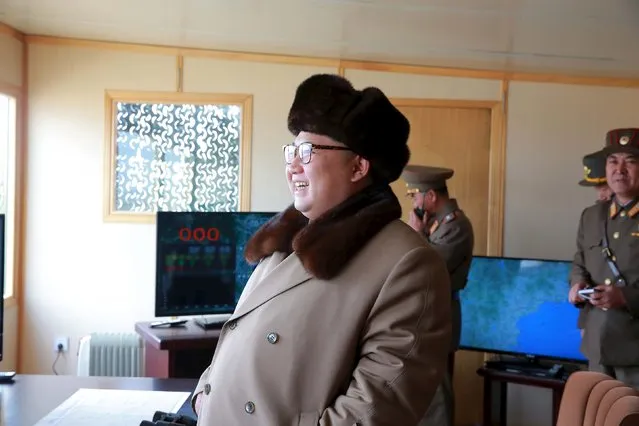 North Korean leader Kim Jong Un (L) smiles as he watches the test of a new type of anti-air guided weapon system in this undated photo released by North Korea's Korean Central News Agency (KCNA) on April 2, 2016. (Photo by Reuters/KCNA)