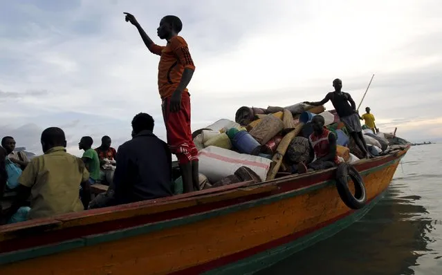 Burundian refugees board a boat on the shores of Lake Tanganyika in Kagunga village in Kigoma region in western Tanzania to Kigoma township, May 17, 2015. (Photo by Thomas Mukoya/Reuters)
