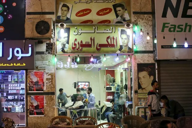 Syrians work at a barber in an area called 6 October City in Giza, Egypt, March 19, 2016. Attracting visitors from across the country, a market mostly run by Syrians fleeing the war has recently gained popularity in Giza. (Photo by Mohamed Abd El Ghany/Reuters)