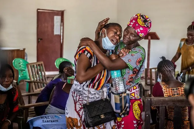 Members of a family mourn after receiving the remains of several family members who were victims of a Kenyan starvation cult at the Malindi Sub-County Hospital Mortuary in Malindi on March 26, 2024. Kenyan authorities on March 26, 2024 released several bodies of worshippers linked to a doomsday starvation cult case dubbed as the “Shakahola forest massacre” that shocked the country and the world. The remains are the first to be handed over to their families after nearly a year of painstaking work to identify them using DNA. (Photo by Luis Tato/AFP Photo)