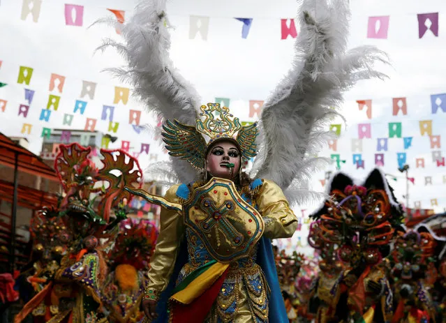 A member of the Diablada group dressed as an angel performs during the carnival parade in Oruro, Bolivia February 25, 2017. (Photo by David Mercado/Reuters)