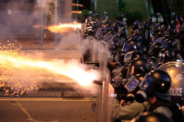 Hong Kong police fire tear gas at protesters in Sai Wan, Hong Kong on Sunday, July 28, 2019. Police fired tear gas at protesters in Hong Kong on Sunday for the second night in a row in another escalation of weeks-long pro-democracy protests in the semi-autonomous Chinese territory. (Photo by Jeff Cheng/HK01 via AP Photo)