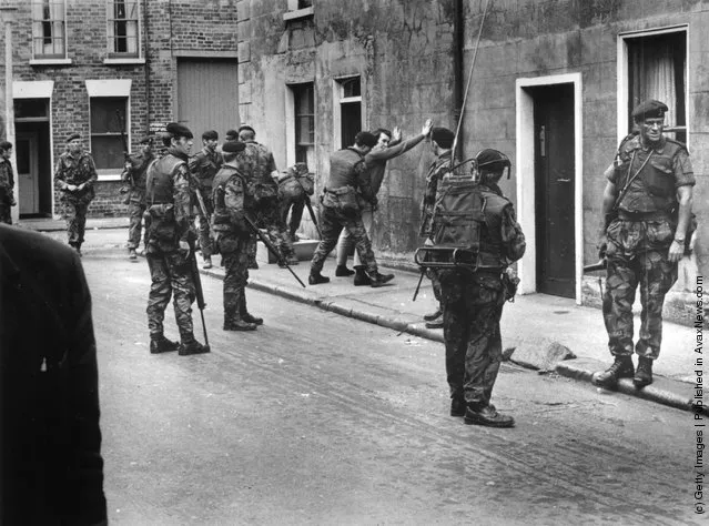 1971:  British troops searching a civilian in Belfast