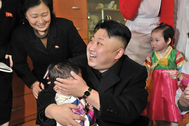This undated picture released from North Korea's official Korean Central News Agency (KCNA) on February 5, 2014 shows North Korean leader Kim Jong-Un (C) visiting the baby home and orphanage in Pyongyang. (Photo by AFP Photo/KCNA via KNS)