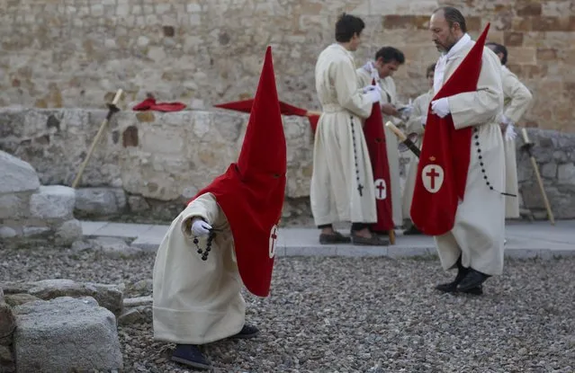 A child dressed as a penitent stands up before taking part on the procession of the Silence with the Santisimo Cristo de las Injurias (Holy Christ of the Insults) brotherhood on April 12, 2017 in Zamora, Spain. Spain celebrates holy week before Easter with processions in most Spanish towns and villages. (Photo by Pablo Blazquez Dominguez/Getty Images)