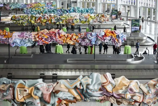 Artworks hover above baggage carousels, revealed at an event previewing the new International Arrivals Facility at Sea-Tac International Airport in Seattle on Thursday,  March 3, 2022. (Photo by Ken Lambert/AP Photo)