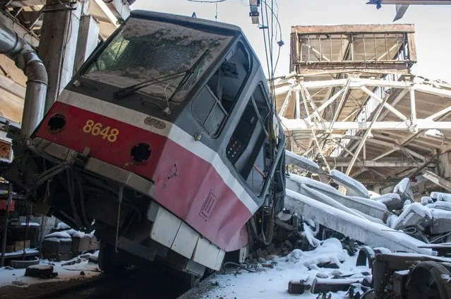 A tram damaged by shelling sits at a tram depot, in Kharkiv, Ukraine, Saturday, March 12, 2022. (Photo by Andrew Marienko/AP Photo)