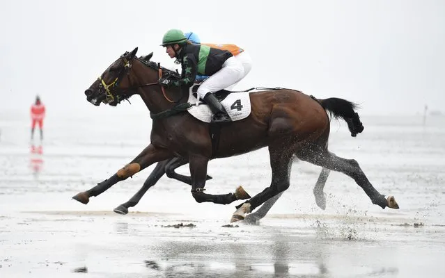 Jockeys ride horses on mud flats during their tideland race (Wadden Race) in Duhnen, Lower Saxony, Germany, July 12, 2015. (Photo by Fabian Bimmer/Reuters)