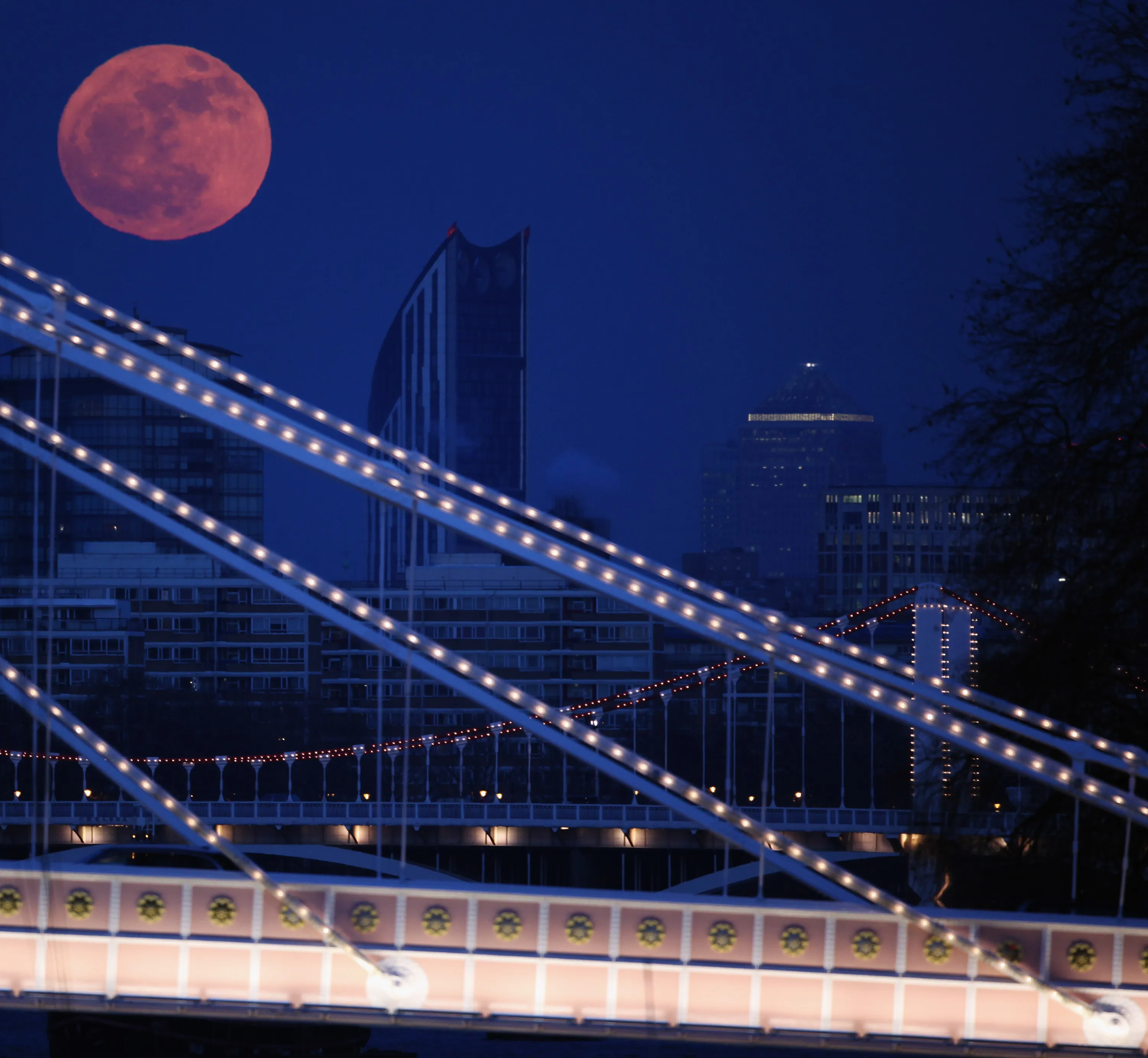 Full Moon Rises Over Albert Bridge In London