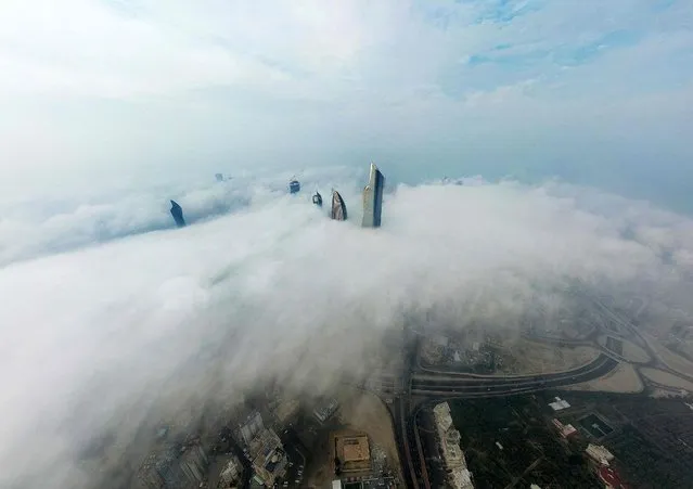A picture taken on January, 2022 from the al-Hamra Tower shows a view of Kuwait City under heavy fog. (Photo by Yasser Al-Zayyat/AFP Photo)