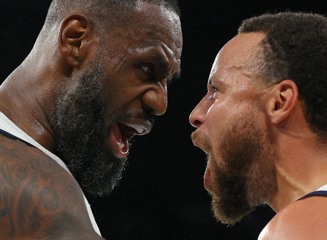 USA's #06 LeBron James (L) celebrates with USA's #04 Stephen Curry at the end of the men's semifinal basketball match between USA and Serbia during the Paris 2024 Olympic Games at the Bercy Arena in Paris on August 8, 2024. (Photo by Brian Snyder/Reuters)