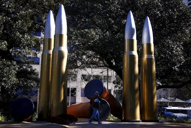 A pedestrian walks past a memorial honouring indigenous servicemen and women who fought for Australia, in Sydney's Hyde Park, July 27, 2015. The memorial of artist Tony Albert, titled “Yininmadyemi Thou didst let fall”, features four giant standing bullets and three fallen shells. (Photo by David Gray/Reuters)