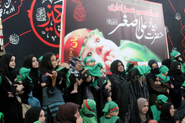 Pakistani Shiite Muslims women with their children attend a mourning procession to mark the sacred month of Muharram, the first month of the Islamic calendar, in Karachi, Pakistan, 12 July 2024. Shiite Muslims across the world are observing the holy month of Muharram, the first month of the Islamic calendar. The climax of Muharram is the Ashura Day that commemorates the martyrdom of Imam Hussein, a grandson of the Prophet Mohammed, who was killed in a battle of the Iraqi city of Karbala in the seventh century. (Photo by Rehan Khan/EPA/EFE)