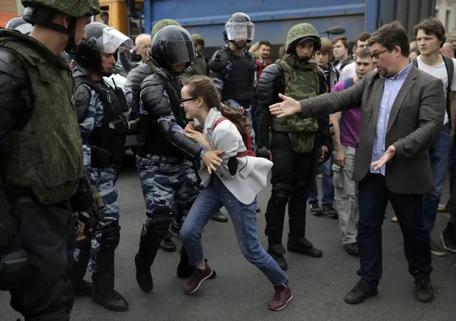 A young girl reacts after her friend was detained by police during a Moscow protest in Moscow, Russia on Monday, June 12, 2017. (Photo by Pavel Golovkin/AP Photo)