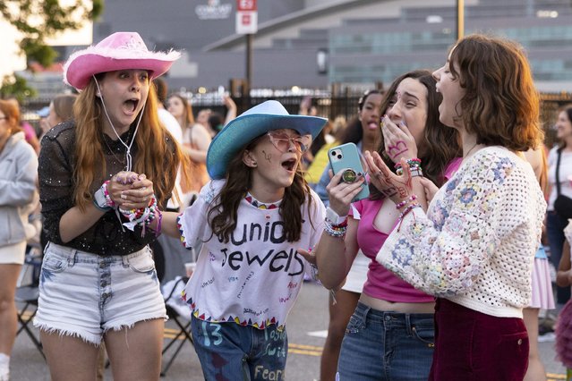 (From left) Shayna Weachter, Cecelia Zschunke, Riley O’Brien, and Rayana Weachter scream when Taylor Swift’s set begins, which they are listening to from the parking lot outside of Lincoln Financial Field, in Philadelphia, Pennsylvania on May 13, 2023. (Photo by Rachel Wisniewski/For the Washington Post)