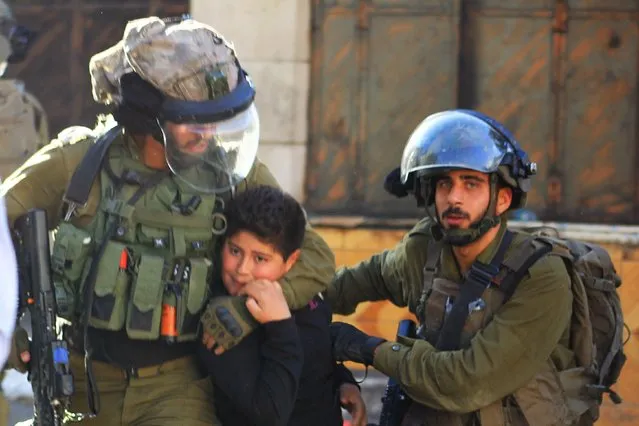 Israeli soldiers detain a 10-year-old Palestinian boy Ismail en-Nicce in Hebron, West Bank on September 23, 2021. Ismail en-Nicce was brutally battered before being taken to a detention center. (Photo by Amer Shallodi/Anadolu Agency via Getty Images)
