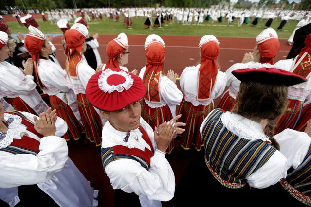 Dancers wear traditional dresses as they perform during women's dance festival in Jogeva, Estonia, June 12, 2016. (Photo by Ints Kalnins/Reuters)