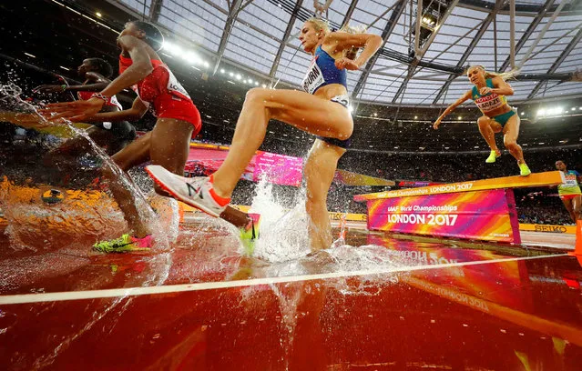 Competitors jump over a water obstacle at the 3000 meters obstacles event during the World Athletics Championships 2017 at the olympic stadium in London, United Kingdom on August 9, 2017. (Photo by Kai Pfaffenbach/Reuters)
