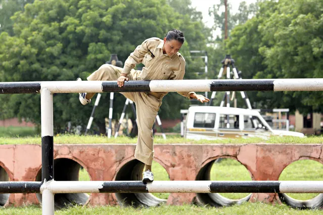 Northeastern girls getting commando training at the Delhi Police Training Centre, Jharoda Kalan on September 4, 2017 in New Delhi, India. For the first time ever, Delhi Police are providing commando training to 40 young women from the Northeast. To become all-rounders, these female commandos have learnt to speak Hindi from their trainers. “This is the first batch from the northeast (to be trained under Delhi Police). Generally, we’ve trained girls from Haryana, Rajasthan, and Uttar Pradesh. Though they’re culturally different, that doesn’t matter when it’s about commando training”, says Om Prakash Sharma, ACP, Chief Commando Inspector. These young women, all in the age group of 18-20 years, are new recruits in the Delhi Police force and they’ve already finished their basic one-month course. Sharma, who has been training recruits for the past 10 years, says that these girls requested him to give them advanced training following the basic course – and he has found them to be highly capable. “These Northeastern girls have completely devoted themselves to this commando training”, says Sharma. “Their day starts from 6am. The routine includes various strength-building and other activities till 6pm. Once the commando training is over, these girls will be a part of the «Parakram Vans», an initiative taken by Delhi Police against terrorism”. (Photo by Manoj Verma/Hindustan Times via Getty Images)